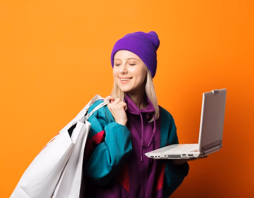 women holding a shopping bag and a laptop