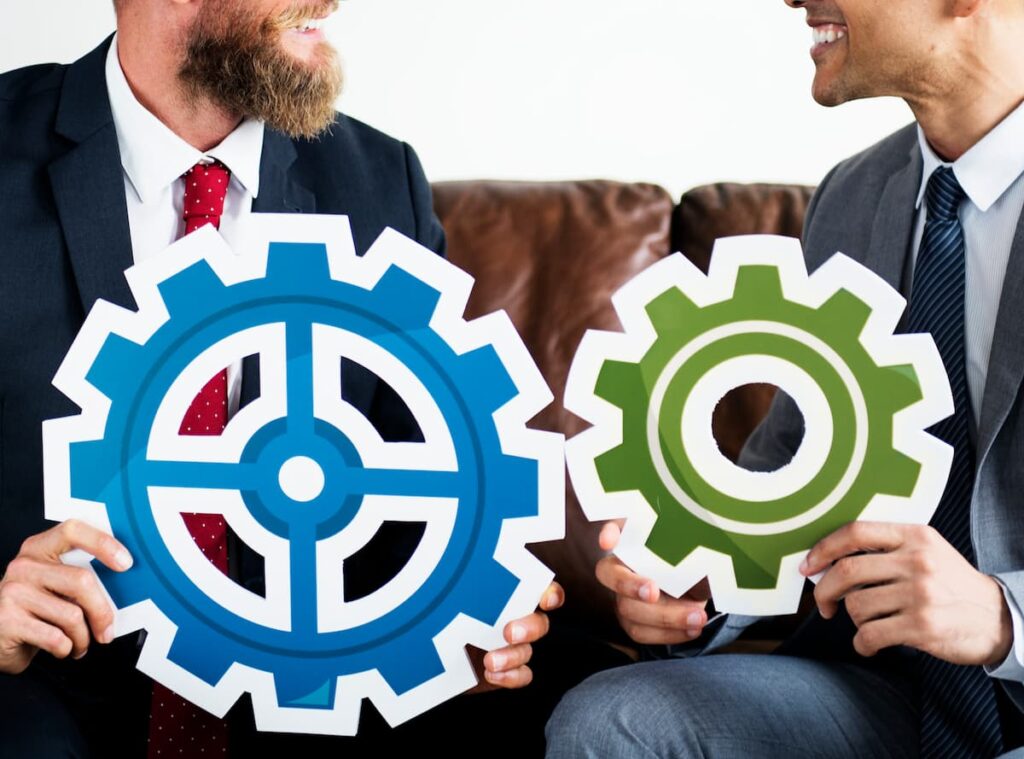 two business men holding flywheels
