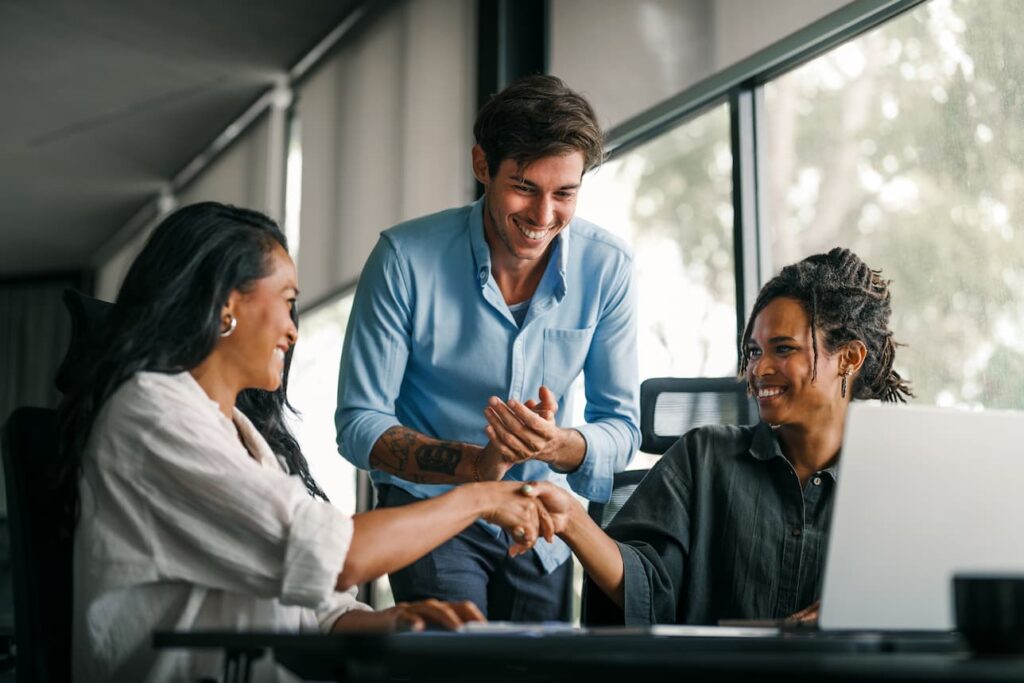 partner marketers fist bumping in celebration